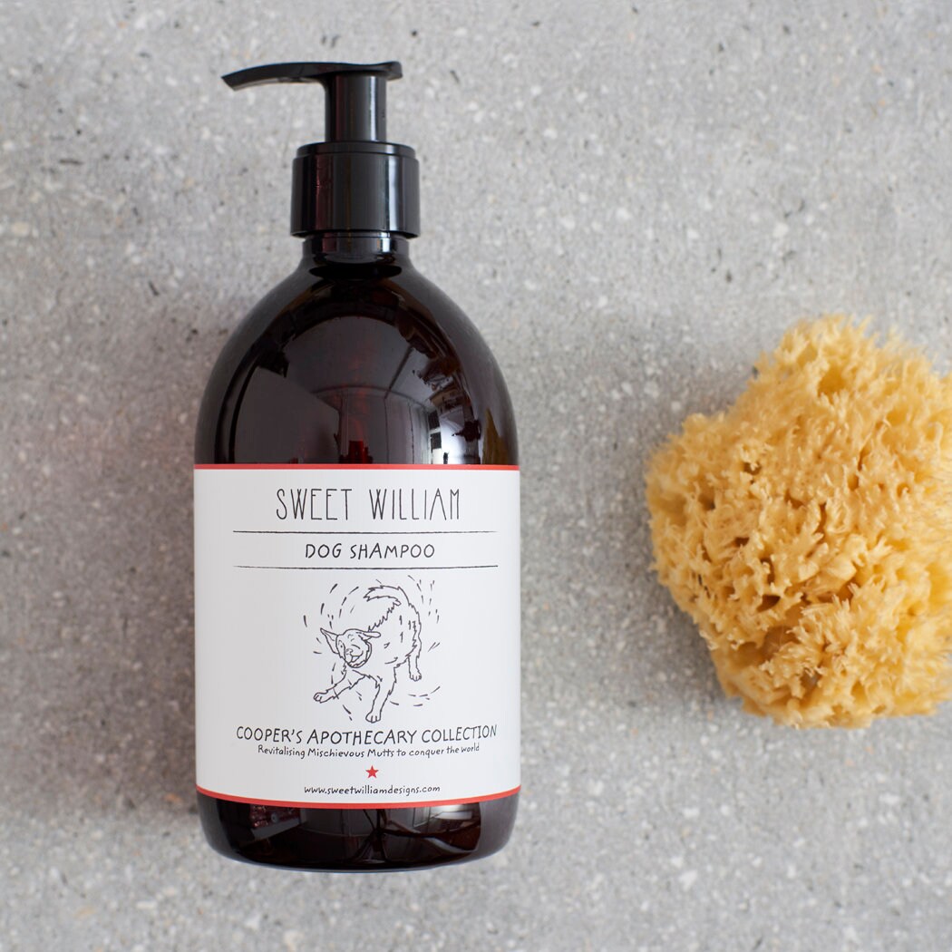 Sweet William Cooper’s Apothecary dog shampoo bottle with a natural sponge, vegan dog shampoo for muddy adventures
