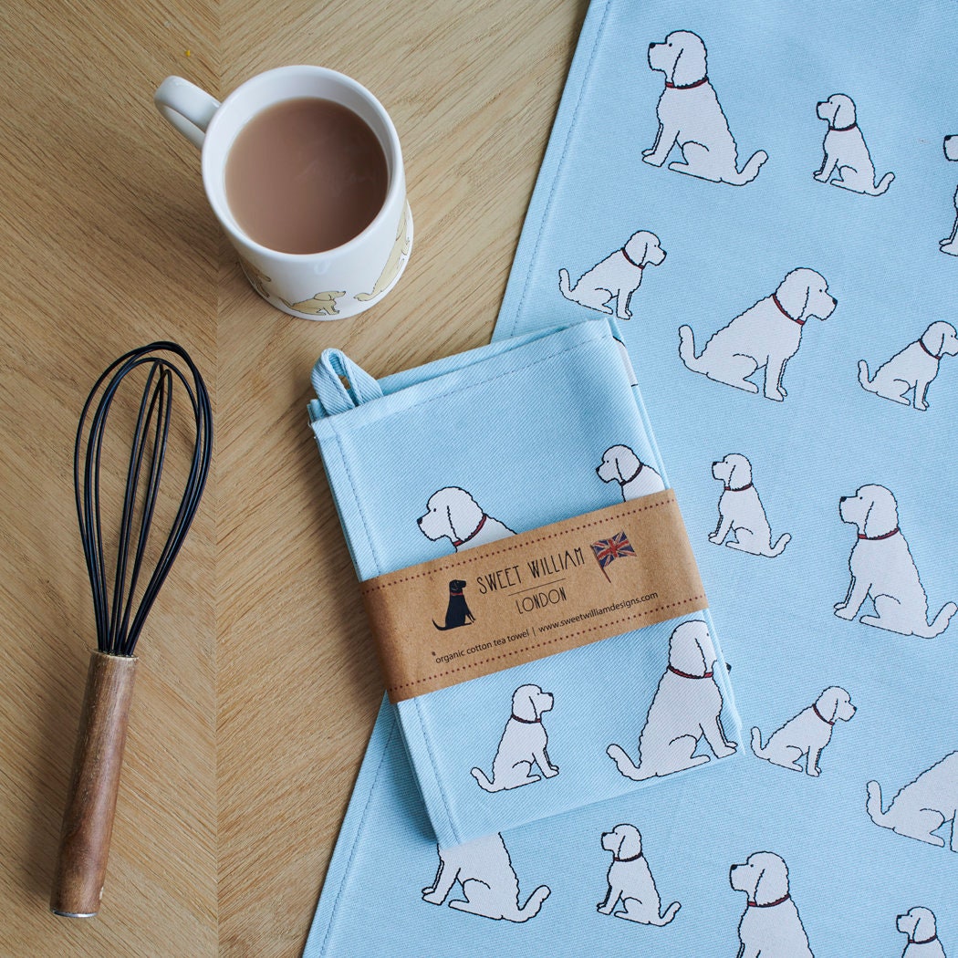 Organic cotton Apricot Cockapoo / Labradoodle tea towel on a wooden table with a matching mug — organic cotton screen printed kitchen gifts for dog lovers by Sweet William Designs.
