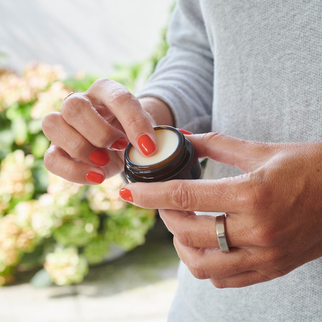 Hands opening Dog Walkers Revival Vegan Lip Balm pot — natural vegan lip balm, thoughtful gift for dog walkers by Sweet William Designs