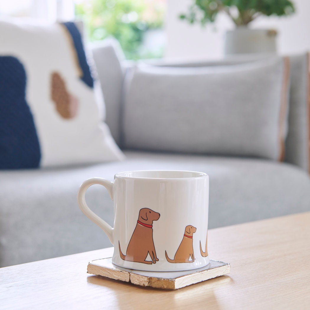 Sweet William Fox Red Labrador Mug on a coffee table — illustrated Fox Red Labrador repeat pattern ceramic mug
