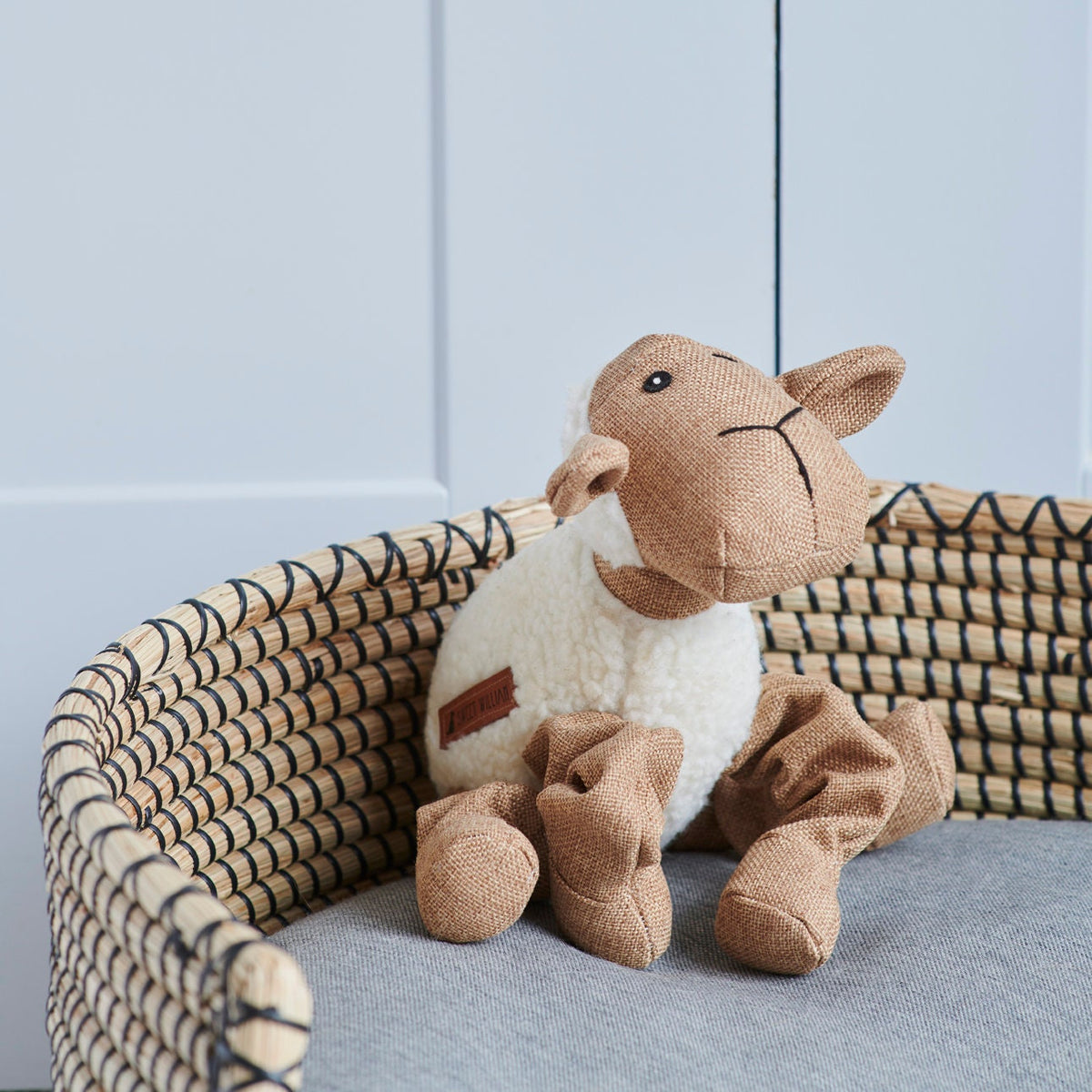 Close-up of Woolliam the Lamb dog toy in a wicker basket — soft fleece and fabric plush toy by Sweet William Designs