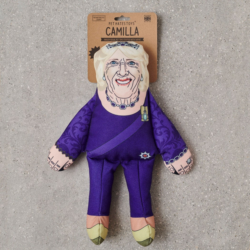 Queen Camilla parody dog toy in purple ceremonial outfit with tiara and sash — funny squeaky dog toy, royal family gift for dog lovers