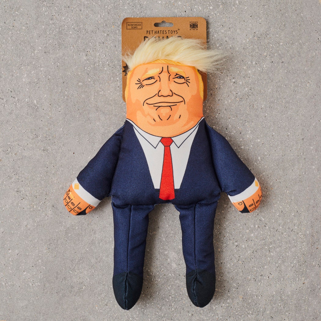 Donald Trump parody dog toy in navy suit with red tie and plush quiff — funny squeaky dog toy, political satire gift for dog lovers