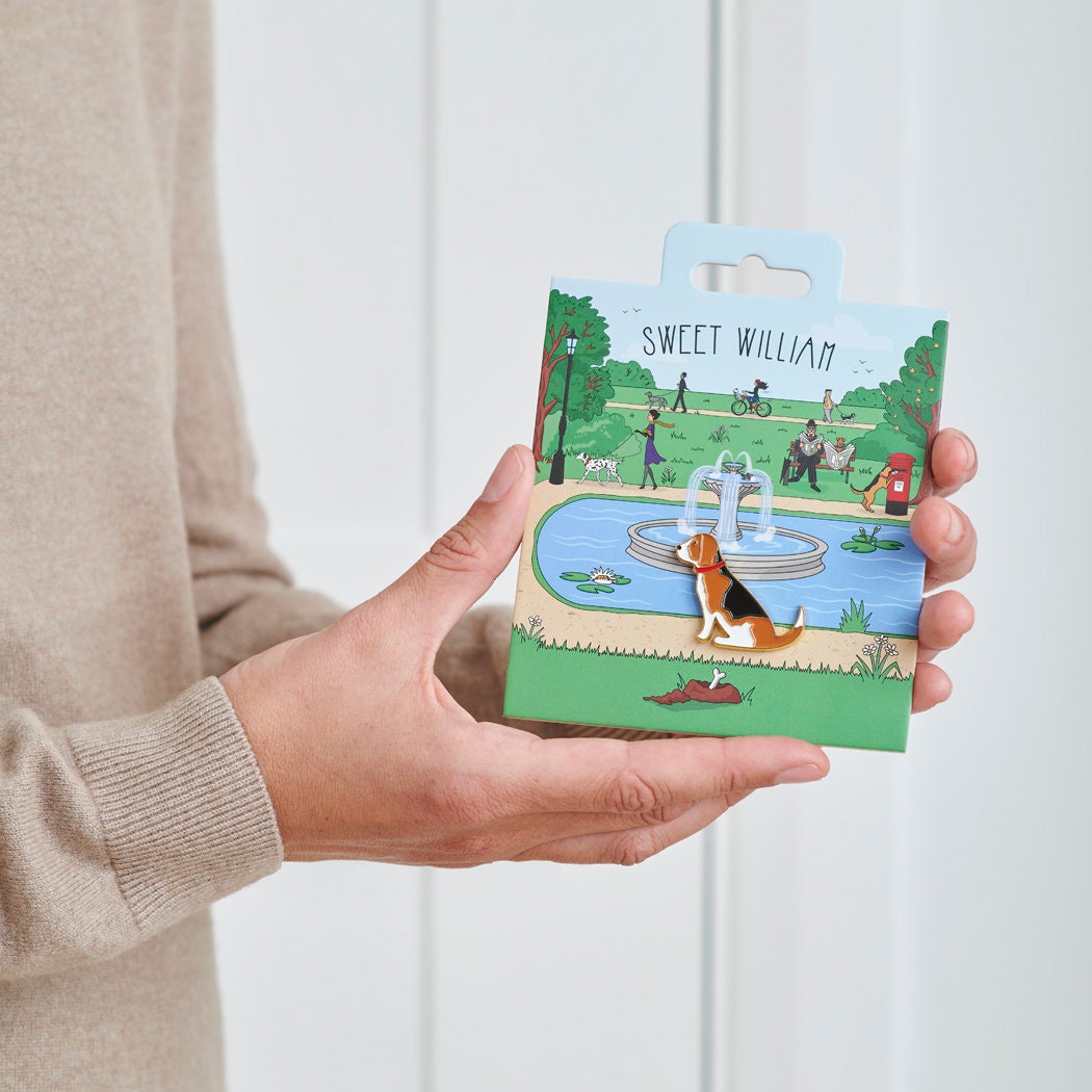 Beagle enamel dog pin held in hands on illustrated park backing card — gold-plated dog lover gift by Sweet William Designs