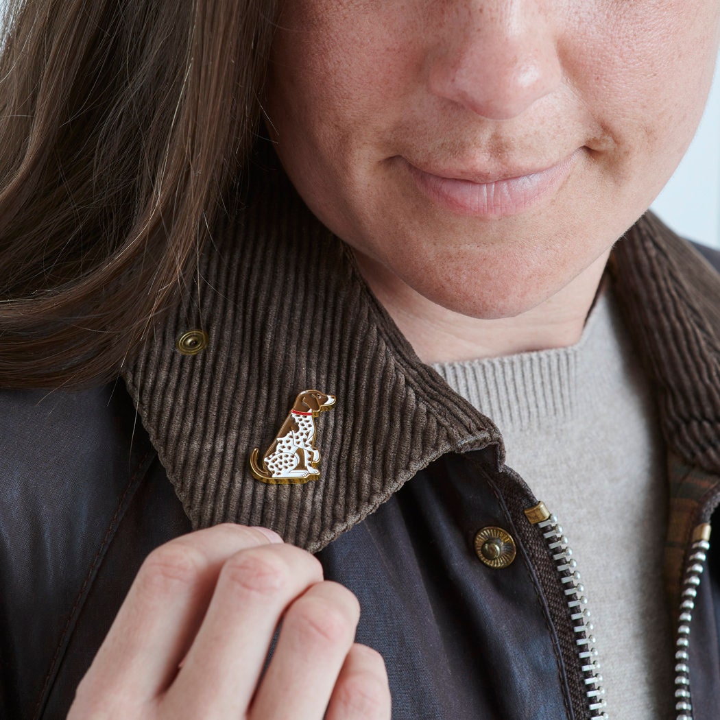 Close-up of German Shorthaired Pointer enamel pin being attached to a corduroy jacket collar — gold-plated dog pin by Sweet William Designs