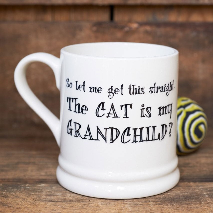 'The Cat Is My Grandchild' ceramic mug — funny gift for cat-loving parents and grandparents by Sweet William Designs