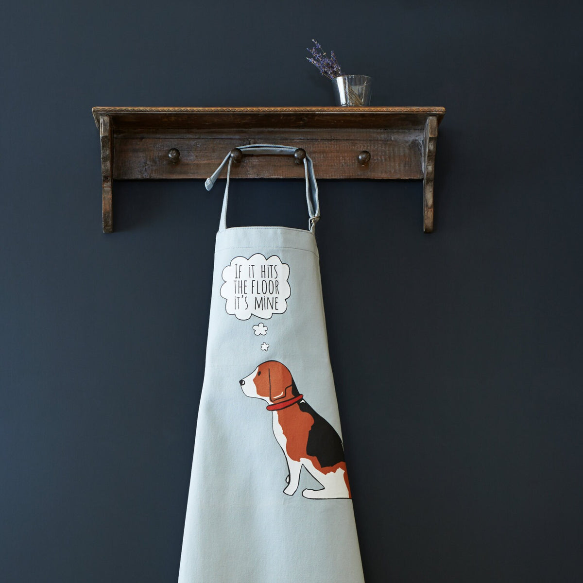 Beagle “If it hits the floor it's mine” organic cotton apron hanging on wooden hooks — a fun gift for dog lovers by Sweet William Designs