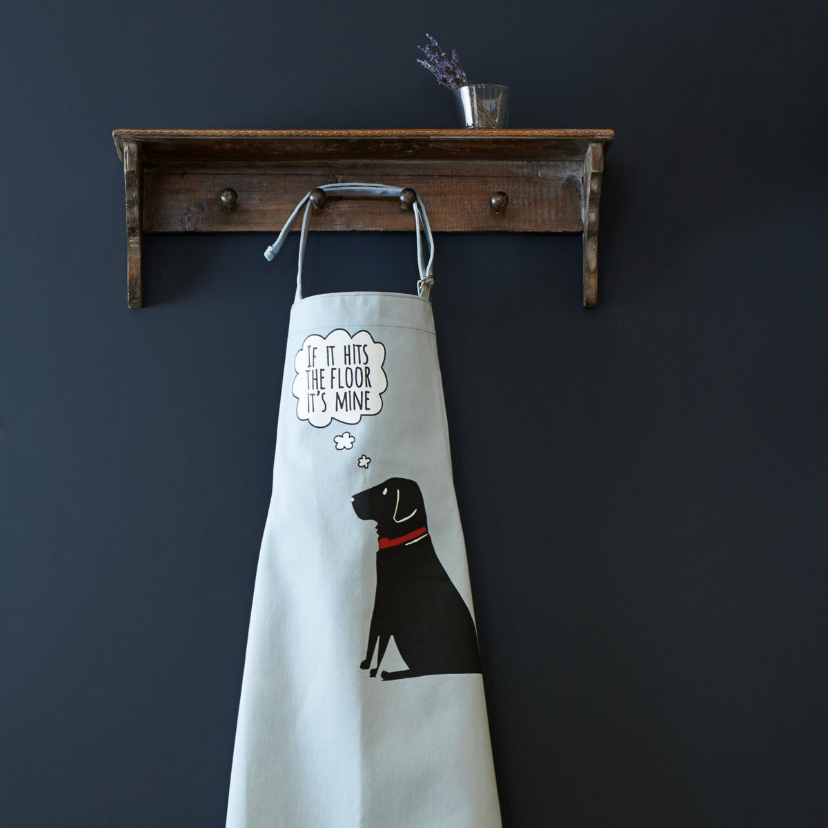 Black Labrador “If it hits the floor it's mine” organic cotton apron hanging on wooden hooks — a fun gift for dog lovers by Sweet William Designs