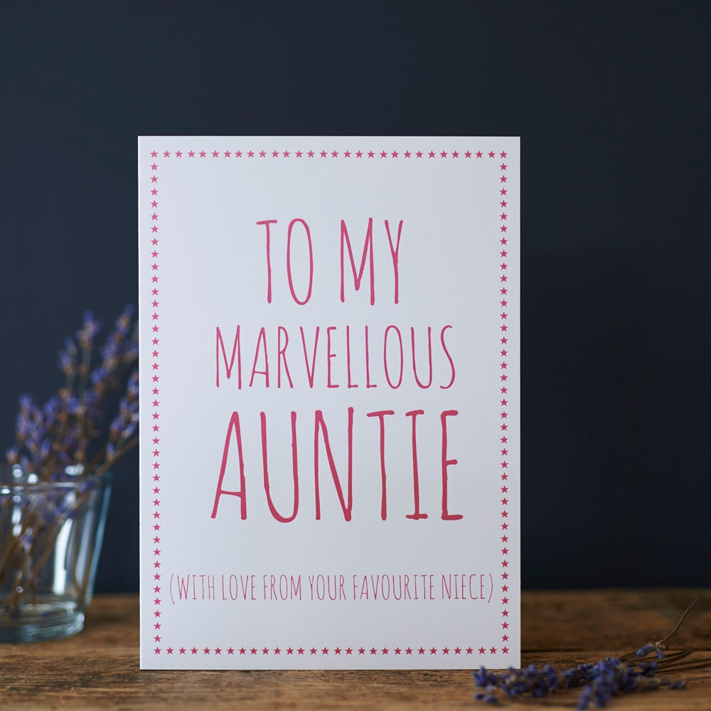White Auntie card with pink lettering reading “To My Marvellous Auntie” and “With love from your favourite niece”, a pink star border and dried flowers beside it.