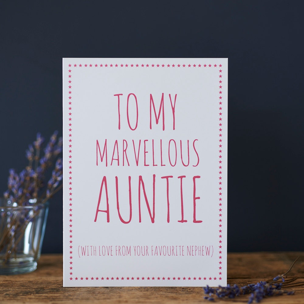 White Auntie card with pink lettering reading “To My Marvellous Auntie” and “With love from your favourite nephew”, a pink star border and dried flowers beside it.