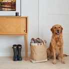 Golden Retriever sitting beside Sweet William jute bag packed with blankets, next to wellies in a hallway — large jute tote bag