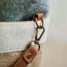 Close-up of tan leather strap and brass hardware on Sweet William jute bag — durable leather handles on natural jute tote