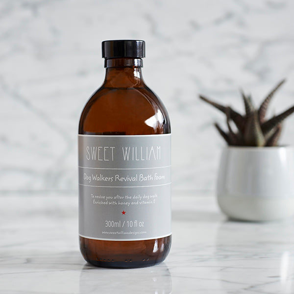Dog Walkers Revival Bath Foam in amber glass bottle on marble surface with plant — part of the Dog Walkers Revival Kit by Sweet William Designs