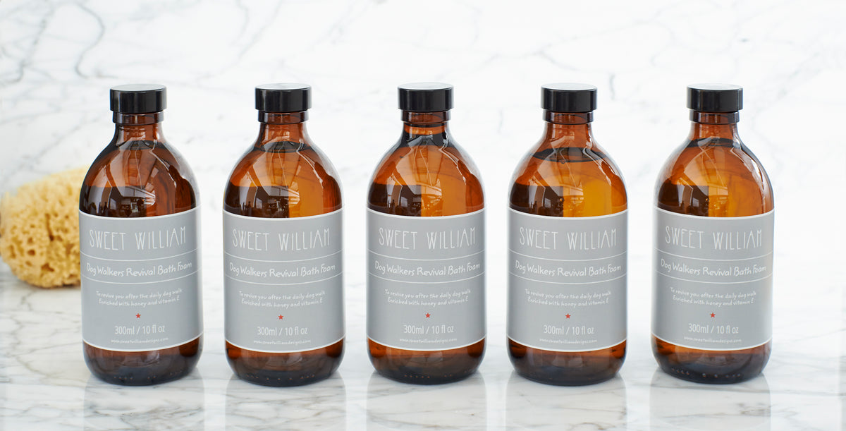 Dog Walkers Revival Bath Foam bottles arranged beside a natural sponge — relaxing bath gift for dog walkers by Sweet William Designs