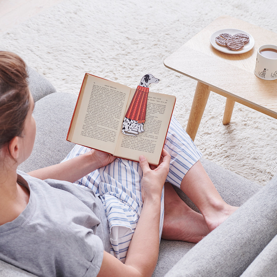 Woman reading a book with a Dalmatian bookmark and matching Dalmatian mug by Sweet William Designs