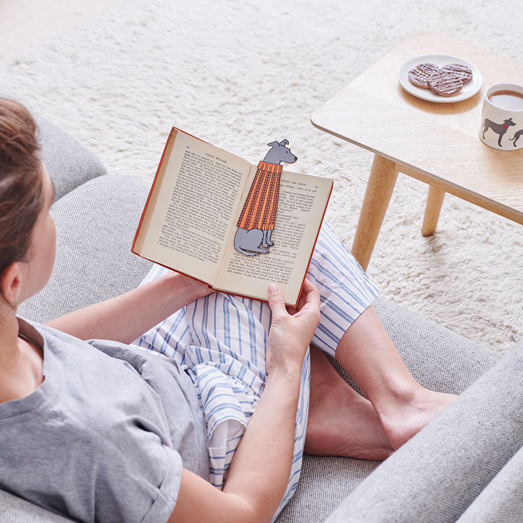 Woman reading a book with a Lurcher bookmark and matching Lurcher mug by Sweet William Designs