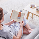 Woman reading a book with a Lurcher bookmark and matching Lurcher mug by Sweet William Designs
