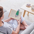Woman reading a book with a Salt & Pepper Schnauzer bookmark and matching Grey Schnauzer mug by Sweet William Designs