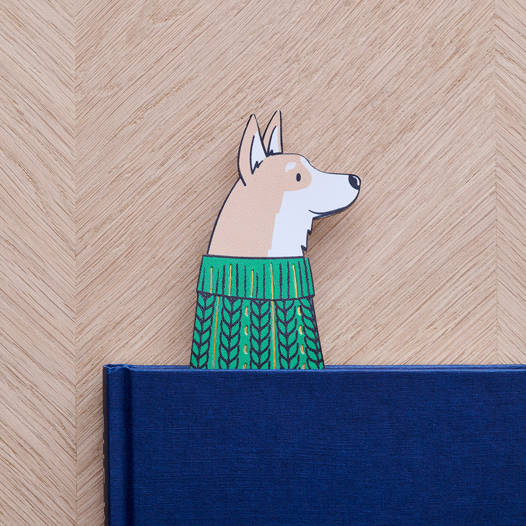 Corgi bookmark peeking out of navy book — illustrated dog in green jumper, vegan PU leather bookmark by Sweet William Designs