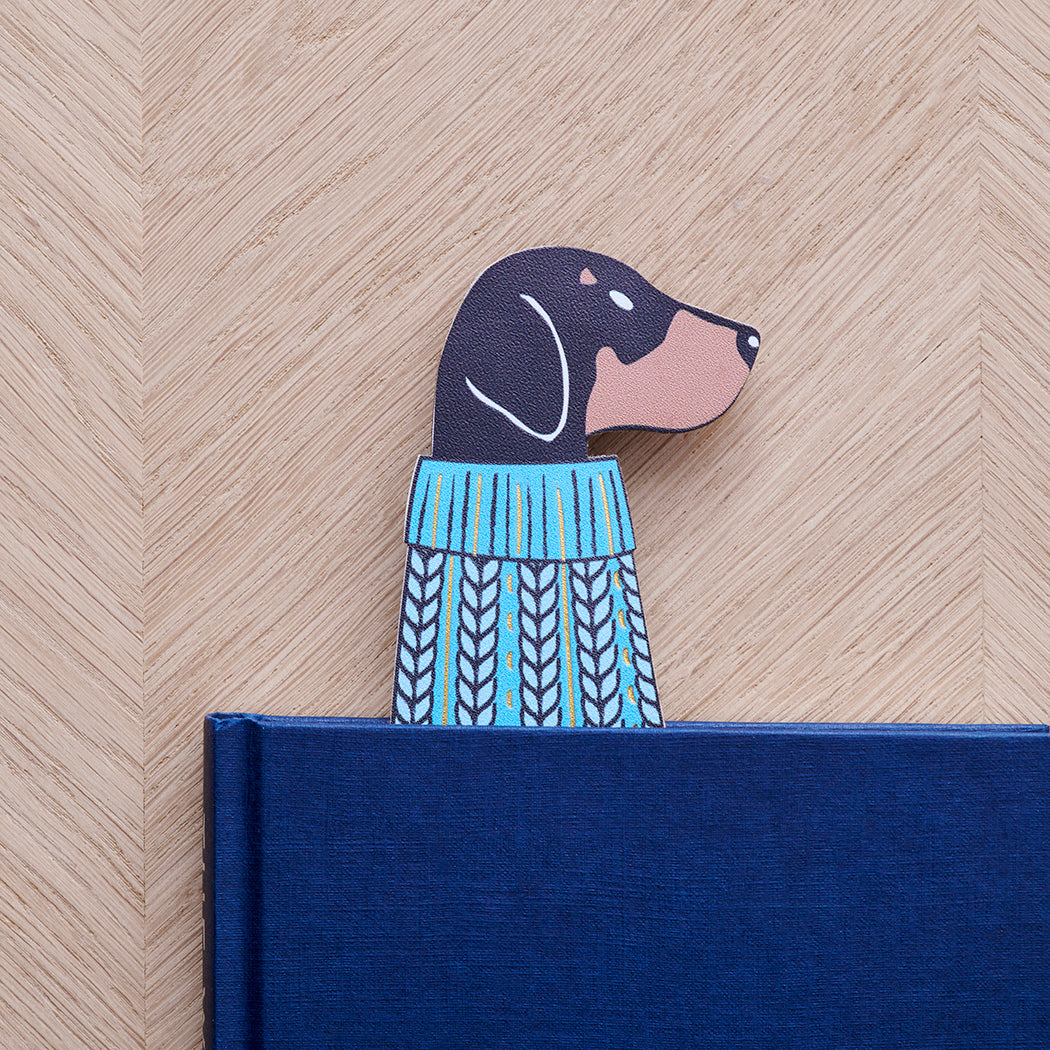 Dachshund bookmark peeking out of navy book — illustrated dog in blue jumper, vegan PU leather bookmark by Sweet William Designs