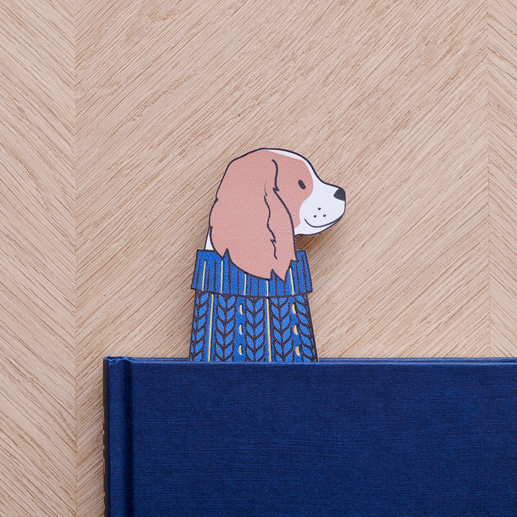 Cavalier King Charles Spaniel bookmark peeking out of navy book — illustrated dog in blue jumper, vegan PU leather bookmark by Sweet William Designs