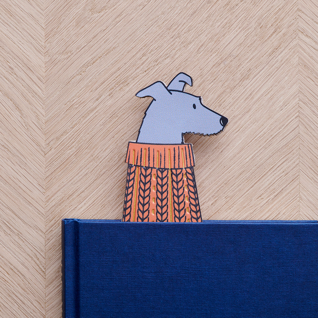 Lurcher bookmark peeking out of navy book — illustrated dog in orange jumper, vegan PU leather bookmark by Sweet William Designs