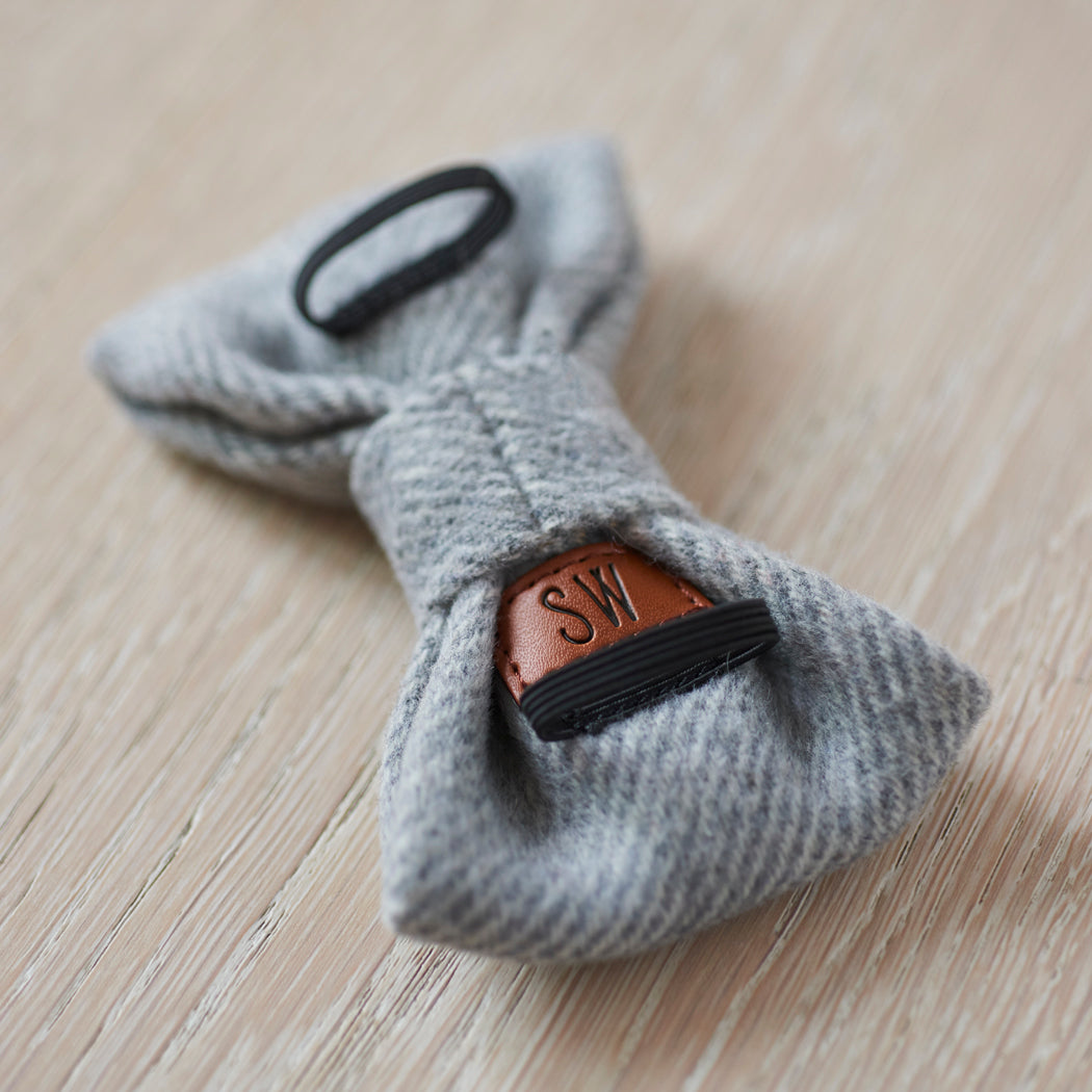 Reverse of a grey tweed dog bow tie showing the elastic collar loops