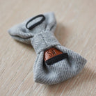 Reverse of a grey tweed dog bow tie showing the elastic collar loops