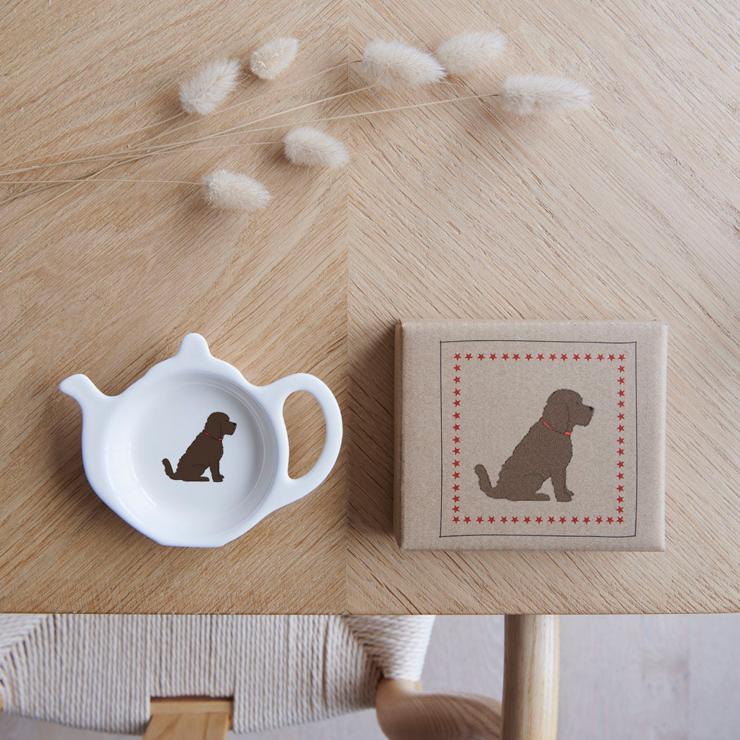 White teapot-shaped Chocolate Cockapoo / Labradoodle teabag dish beside its kraft gift box, both featuring a brown curly-coated dog illustration