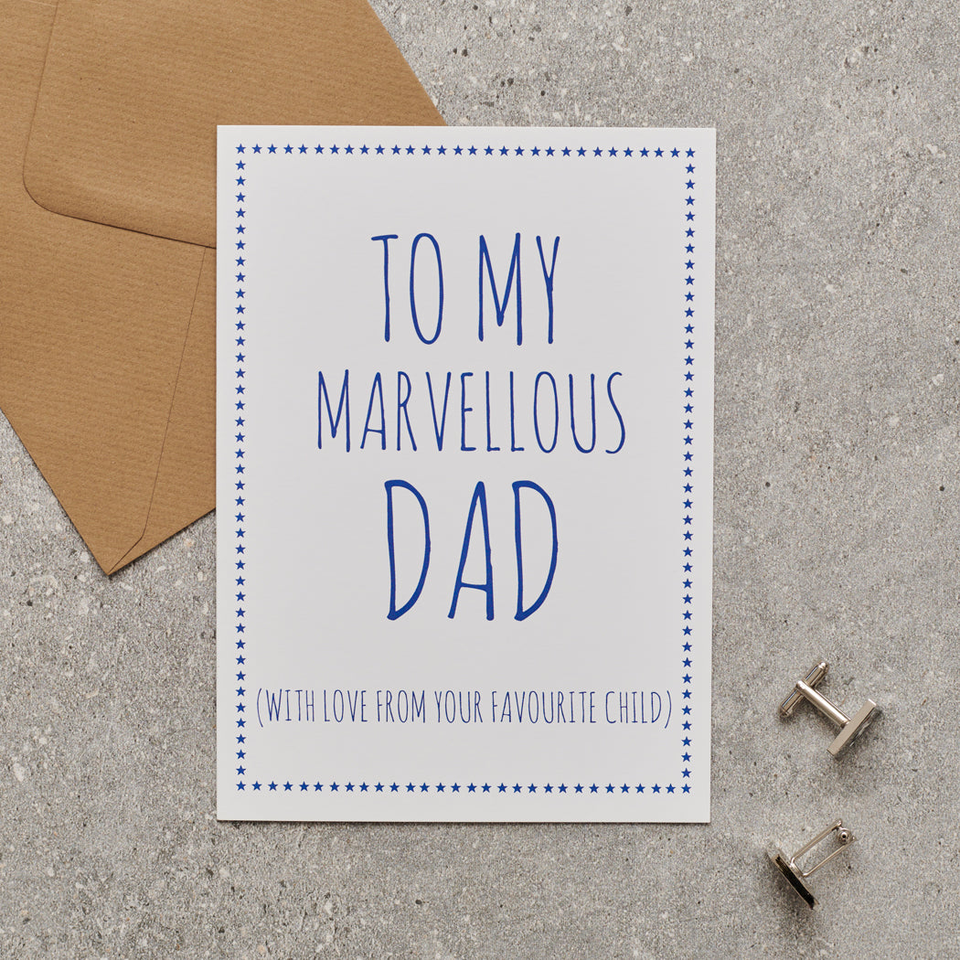 White Dad card with blue lettering reading “To My Marvellous Dad” and “With love from your favourite child”, a blue star border, kraft envelope and silver cufflinks.