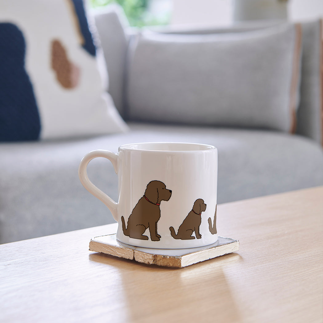 Sweet William Chocolate Cockapoo Mug on a coffee table — illustrated Cockapoo repeat pattern ceramic mug