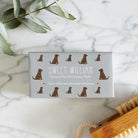Close-up of Chocolate Labrador soap packaging — Sweet William triple milled soap enriched with honey, featuring an illustrated Chocolate Labrador repeat pattern