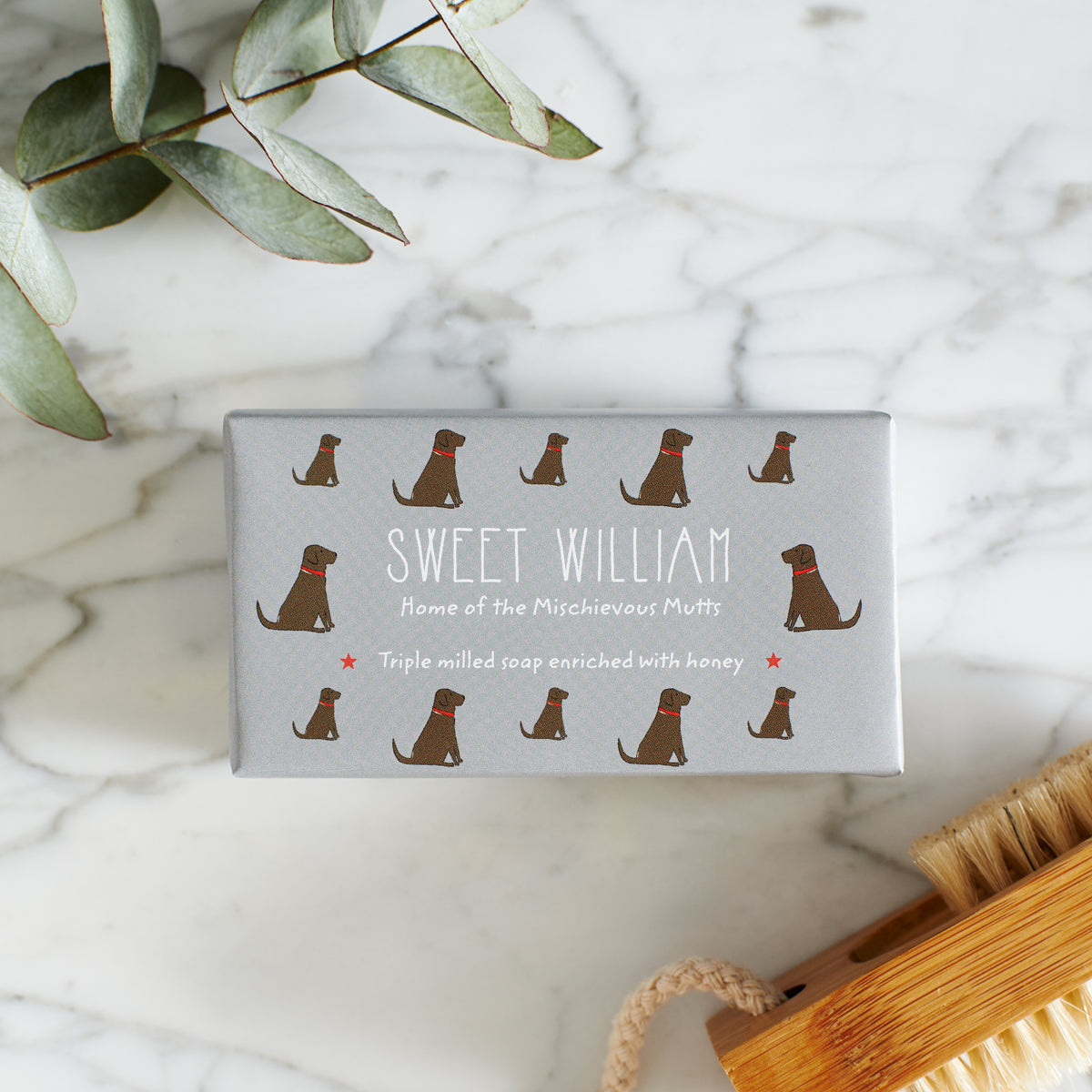 Close-up of Chocolate Labrador soap packaging — Sweet William triple milled soap enriched with honey, featuring an illustrated Chocolate Labrador repeat pattern