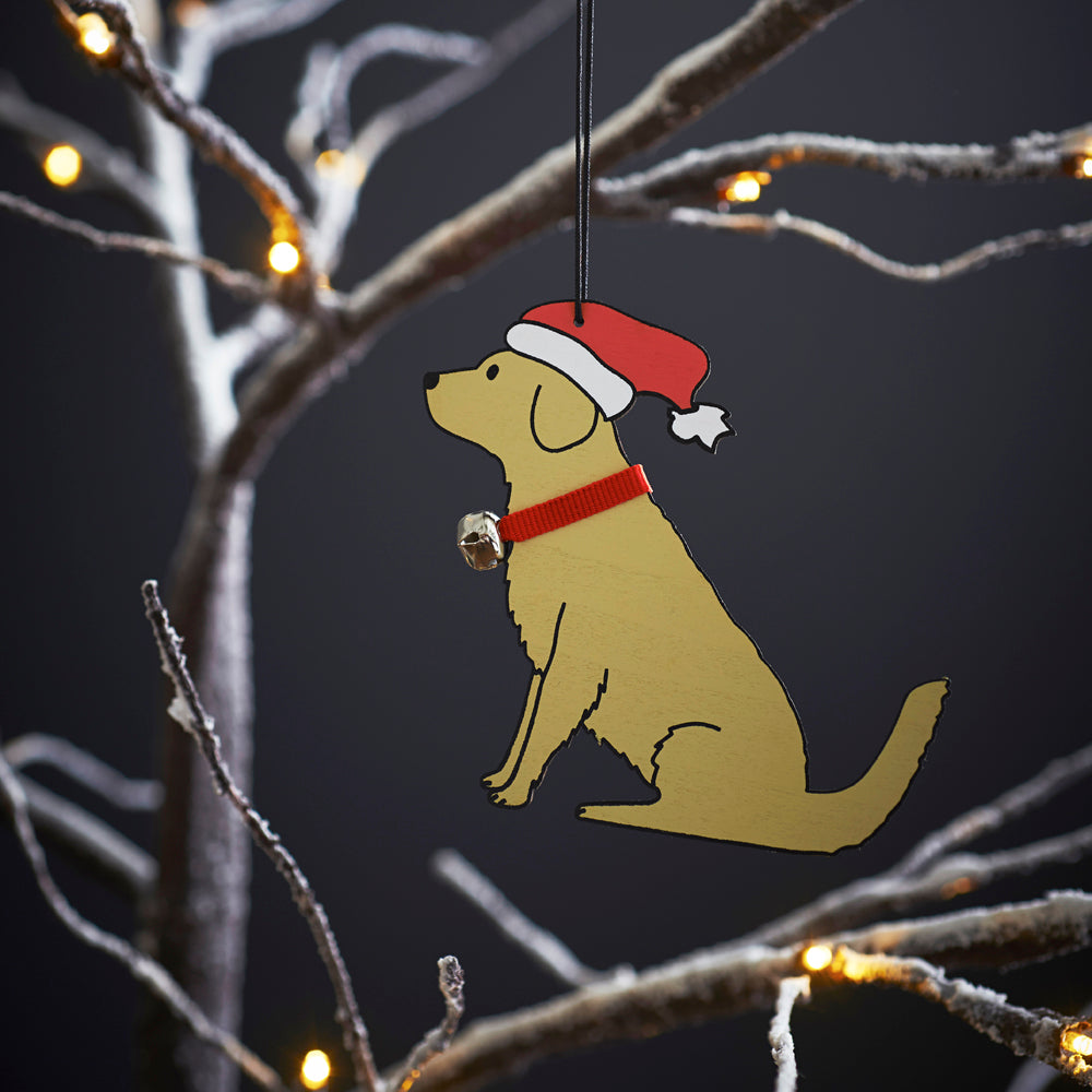 Golden Retriever Christmas tree decoration hanging on lit winter tree — wooden dog decoration with Father Christmas hat and jingle bell collar by Sweet William Designs