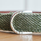 Close-up of the branded D-ring on a green tweed dog collar