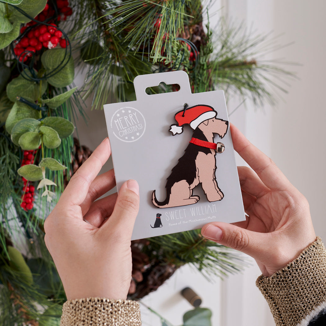 Airedale / Lakeland / Welsh Terrier Christmas tree decoration held in hands on backing card — Father Christmas hat and jingle bell collar, dog lover gift by Sweet William Designs