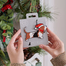 Basset Hound Christmas tree decoration held in hands on backing card — Father Christmas hat and jingle bell collar, dog lover gift by Sweet William Designs