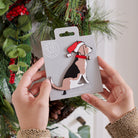 Beagle Christmas tree decoration held in hands on backing card — Father Christmas hat and jingle bell collar, dog lover gift by Sweet William Designs