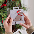 Chocolate Cocker Spaniel Christmas tree decoration held in hands on backing card — Father Christmas hat and jingle bell collar, dog lover gift by Sweet William Designs