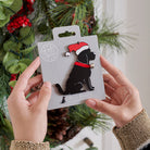 Black Cockapoo / Labradoodle Christmas tree decoration held in hands on backing card — Father Christmas hat and jingle bell collar, dog lover gift by Sweet William Designs