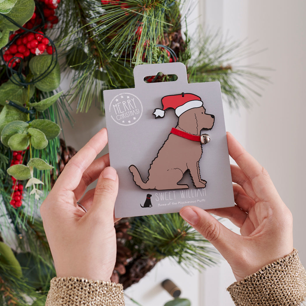Chocolate Cockapoo / Labradoodle Christmas tree decoration held in hands on backing card — Father Christmas hat and jingle bell collar, dog lover gift by Sweet William Designs