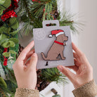 Chocolate Cockapoo / Labradoodle Christmas tree decoration held in hands on backing card — Father Christmas hat and jingle bell collar, dog lover gift by Sweet William Designs