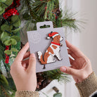 Cavalier King Charles Spaniel Christmas tree decoration held in hands on backing card — Father Christmas hat and jingle bell collar, dog lover gift by Sweet William Designs