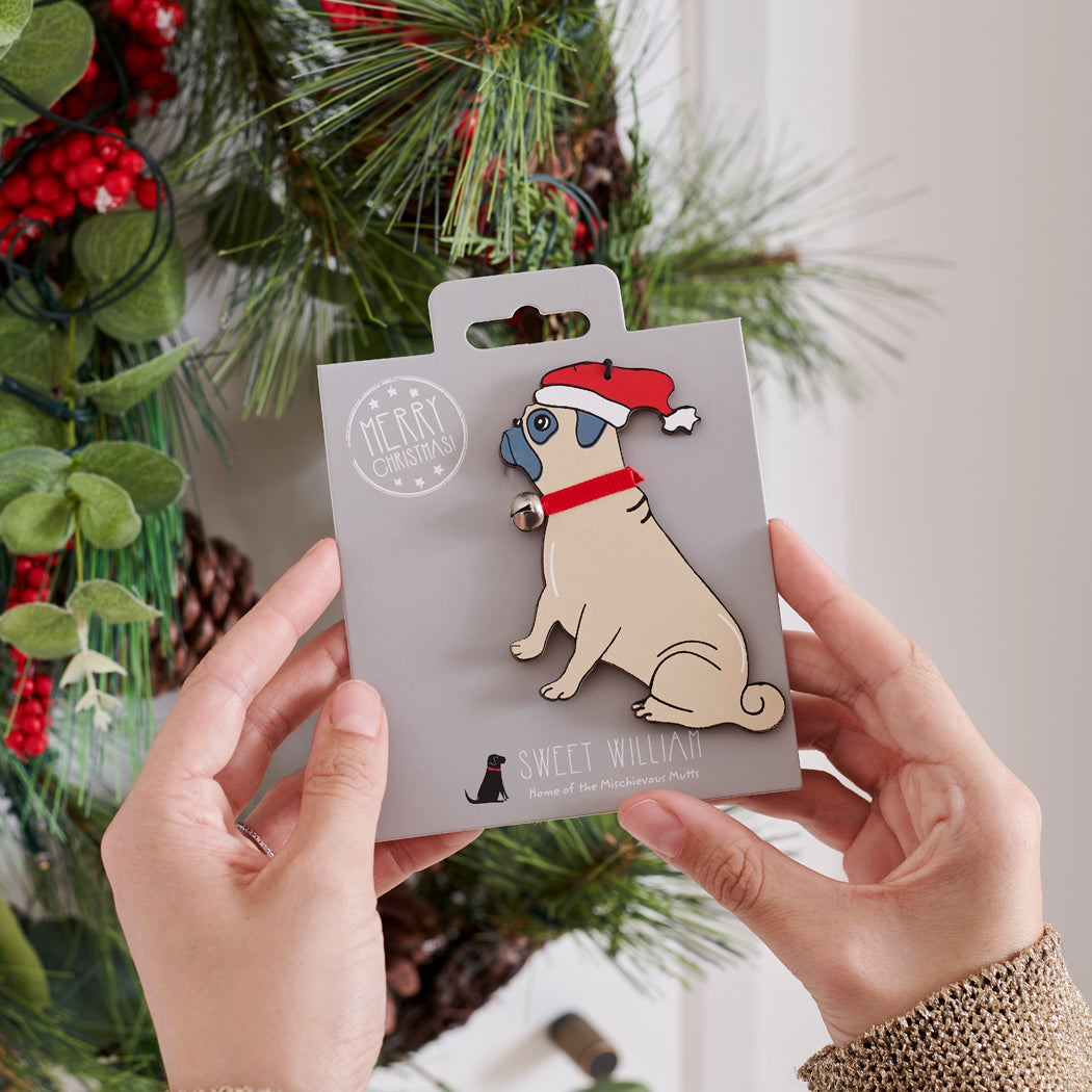 Pug Christmas tree decoration held in hands on backing card — Father Christmas hat and jingle bell collar, dog lover gift by Sweet William Designs