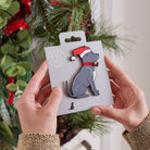 Staffie Christmas tree decoration held in hands on backing card — Father Christmas hat and jingle bell collar, dog lover gift by Sweet William Designs