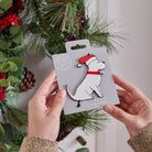 Westie Christmas tree decoration held in hands on backing card — Father Christmas hat and jingle bell collar, dog lover gift by Sweet William Designs
