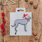 Lurcher Christmas decoration on backing card — wooden dog decoration with Father Christmas hat and jingle bell collar, festive dog lover gift by Sweet William Designs