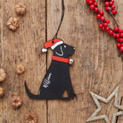 Personalised Black Labrador Christmas decoration with name — wooden dog decoration with Father Christmas hat and jingle bell collar, thoughtful dog lover gift by Sweet William Designs