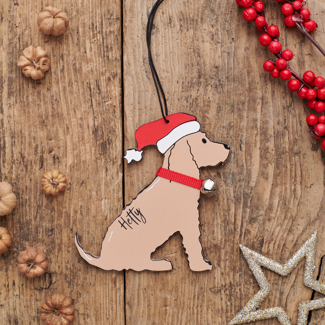 Personalised Golden Cocker Spaniel Christmas decoration with name — wooden dog decoration with Father Christmas hat and jingle bell collar, thoughtful dog lover gift by Sweet William Designs