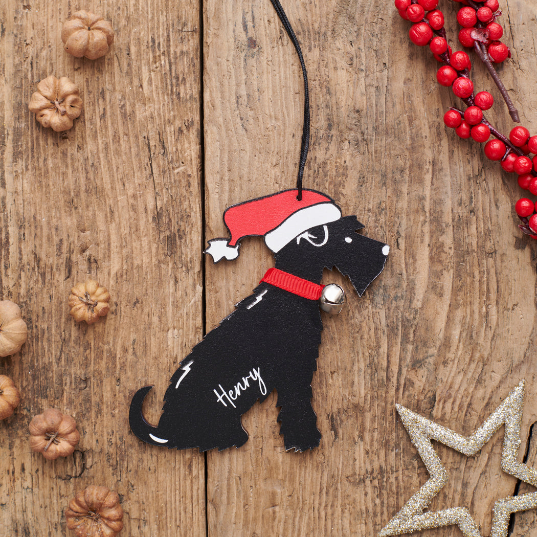 Personalised Black Schnauzer Christmas decoration with name — wooden dog decoration with Father Christmas hat and jingle bell collar, thoughtful dog lover gift by Sweet William Designs